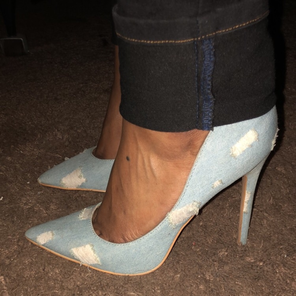 Light denim distressed pointy toe pumps.
